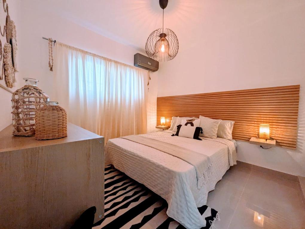a bedroom with a bed and a large window at Boho Vibes Punta Cana in Punta Cana