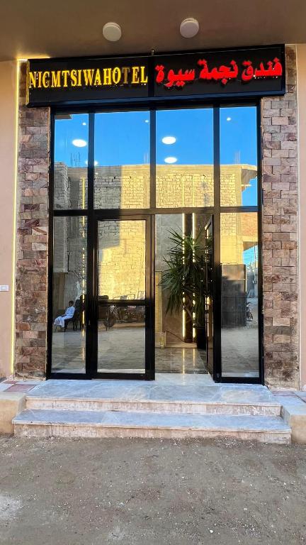 a store front with a sign on the front of a building at Negmet Siwa Hotel in Siwa