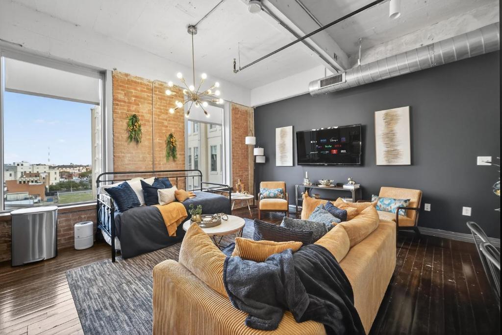 a living room with two couches and a table at Urban Luxe Loft in Dallas