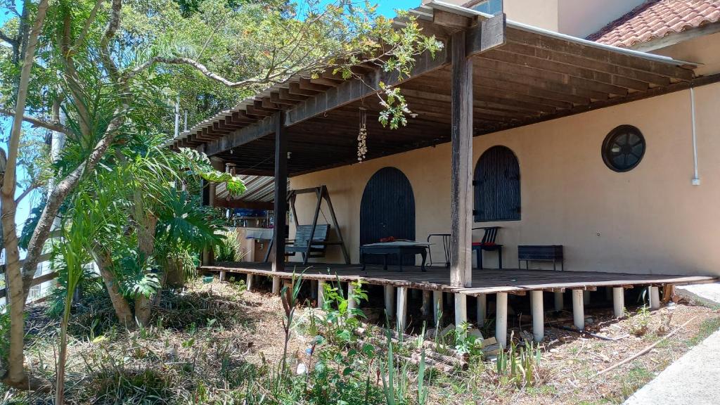a porch of a house with a wooden deck at Ninho da Águia - Chalés in Poços de Caldas