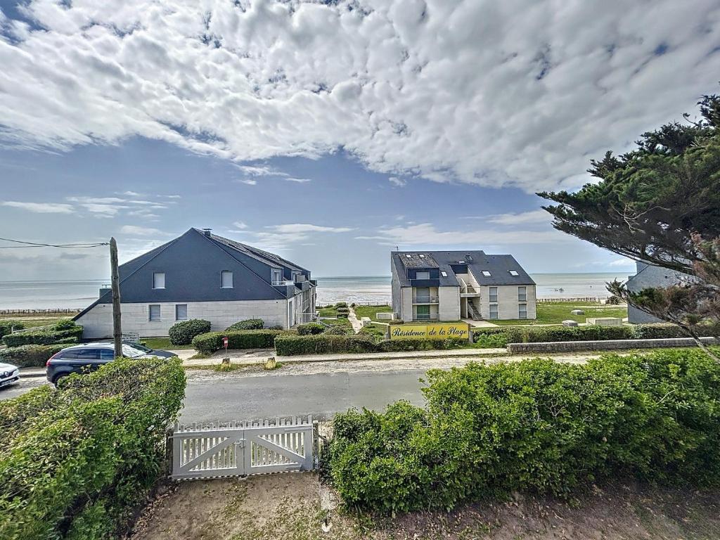 a view of a street with houses and a car at Maison de vacances à 20m de la plage, jardin clos, Wi-Fi, idéale famille - FR-1-361-163 in Jullouville-les-Pins