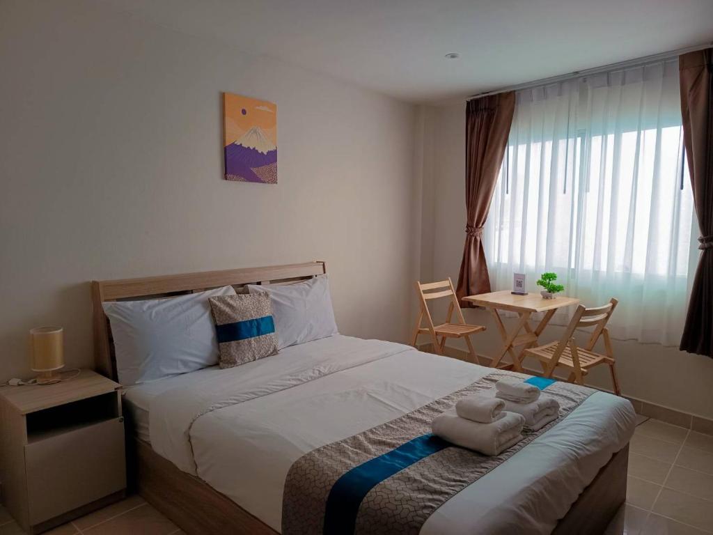 Postel nebo postele na pokoji v ubytování Amai Pancakery and Residence