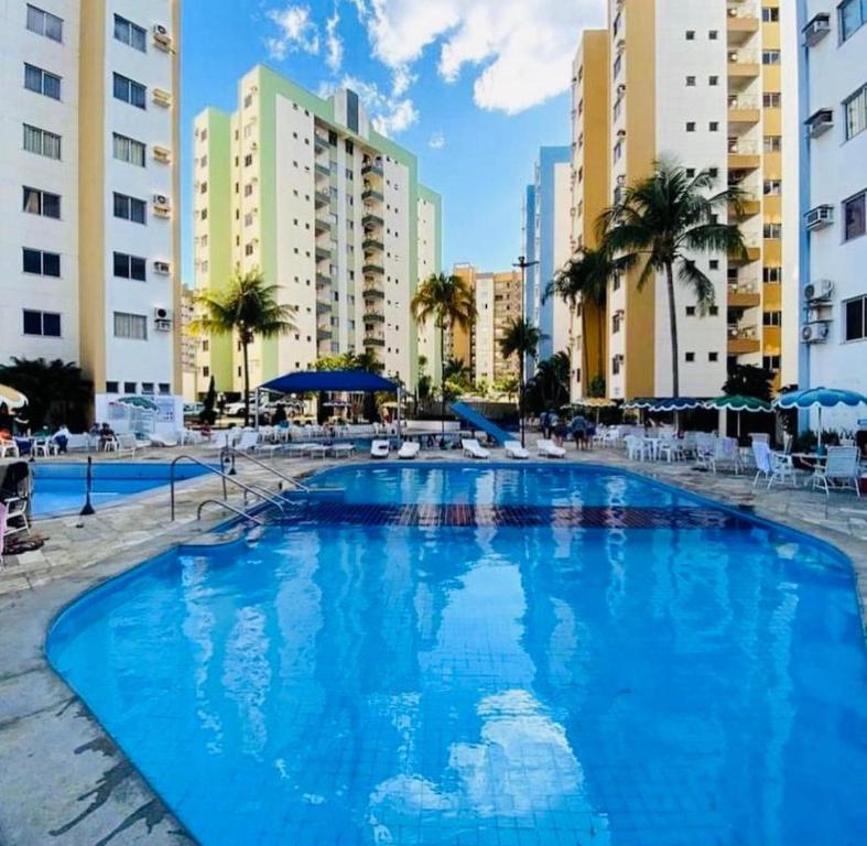 a large swimming pool in a resort with buildings at Apartamento 2 Quartos Caldas Novas in Caldas Novas