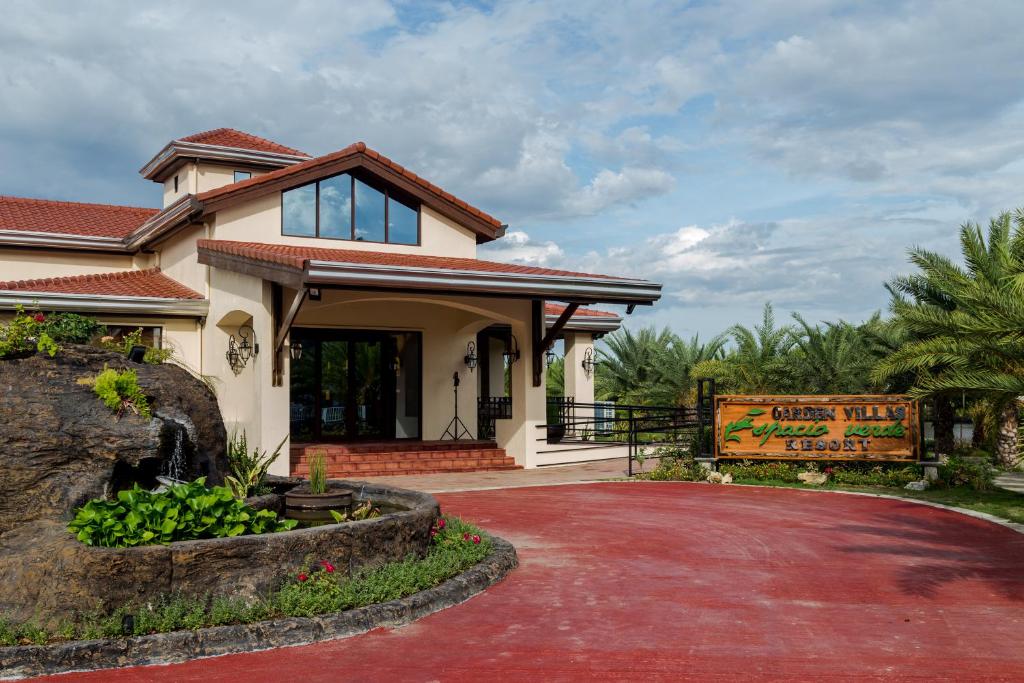 a house with a red brick driveway at Espacio Verde Resort in Roxas City