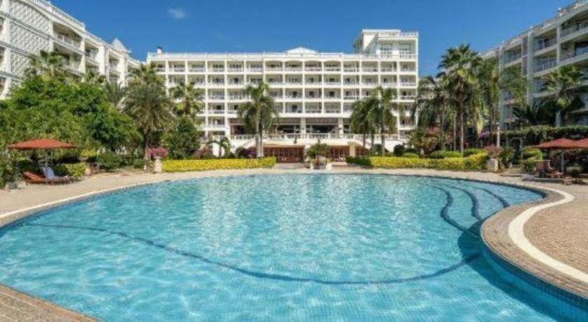 a large swimming pool in front of a building at Sanya Summer Beach Sea View Hotel in Sanya