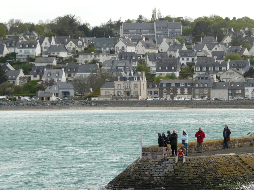 Un groupe de personnes debout sur une jetée près de l'eau dans l'établissement Tourellic, à Binic