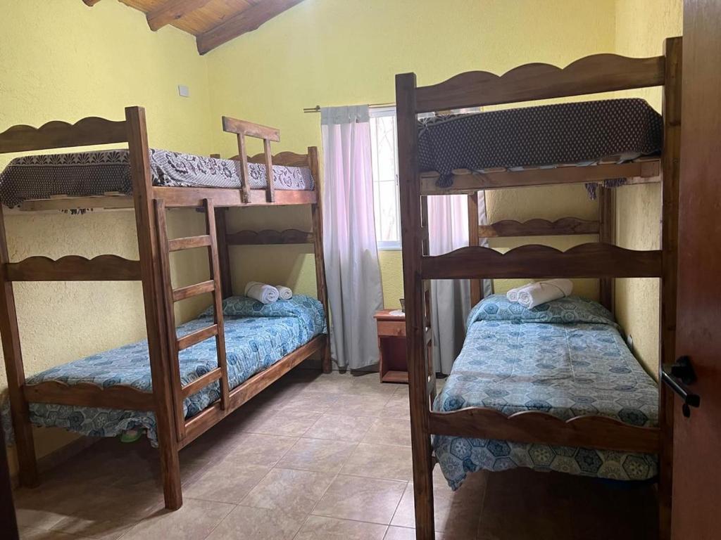 a room with three bunk beds in a room at cabañas elita in San Rafael