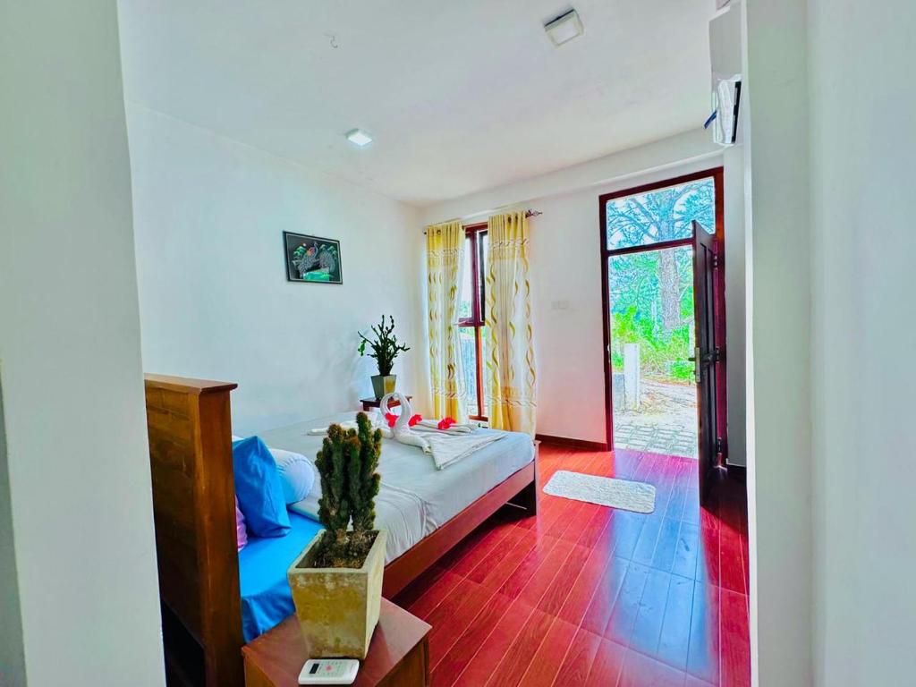 a bedroom with a bed and a large window at The Ceylan Crest ELLA in Ella