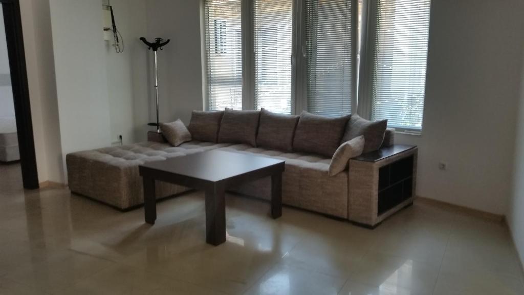 a living room with a couch and a coffee table at 4U Apartment in Burgas City