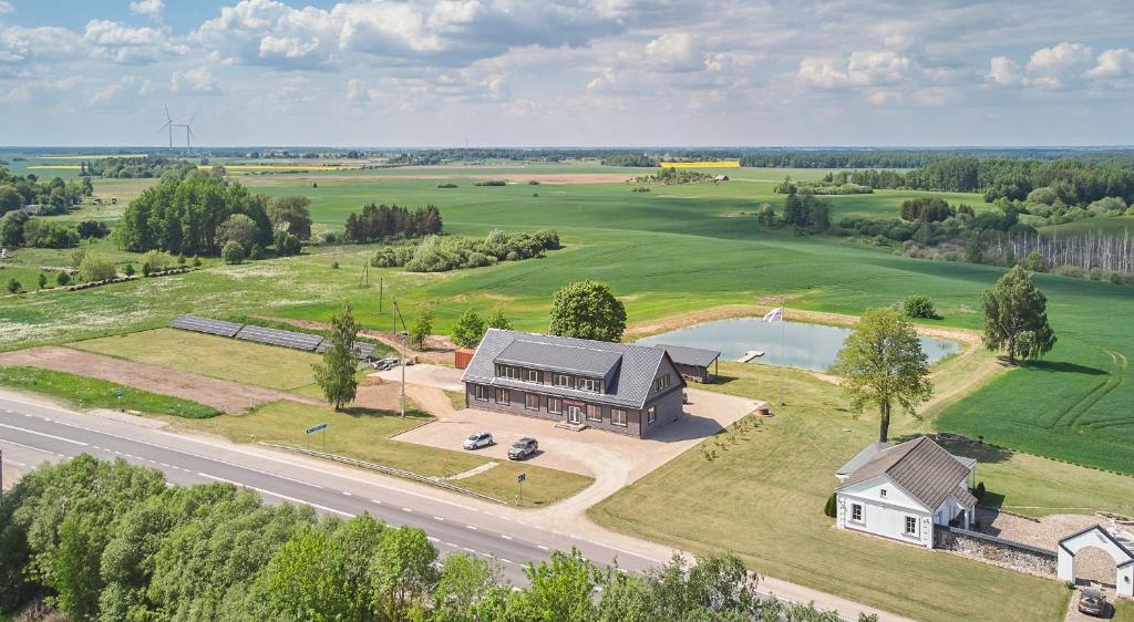 an aerial view of a large house with a lake at Bebryno slėnis in Staškūniškis