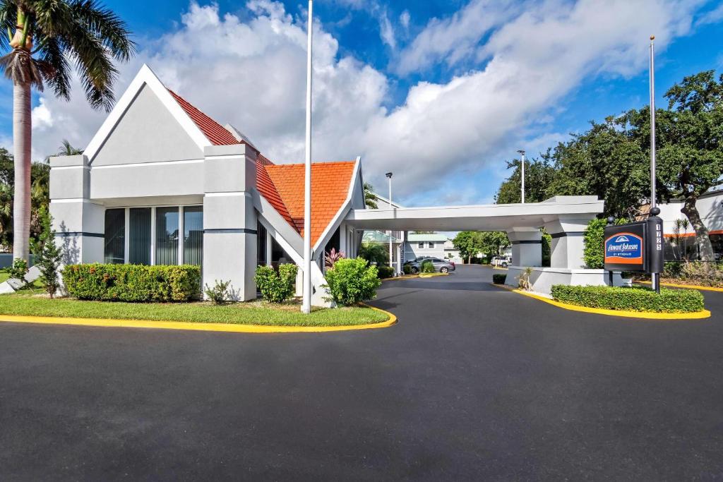 a large white building with a gas station at Howard Johnson by Wyndham Vero Beach / Downtown in Vero Beach
