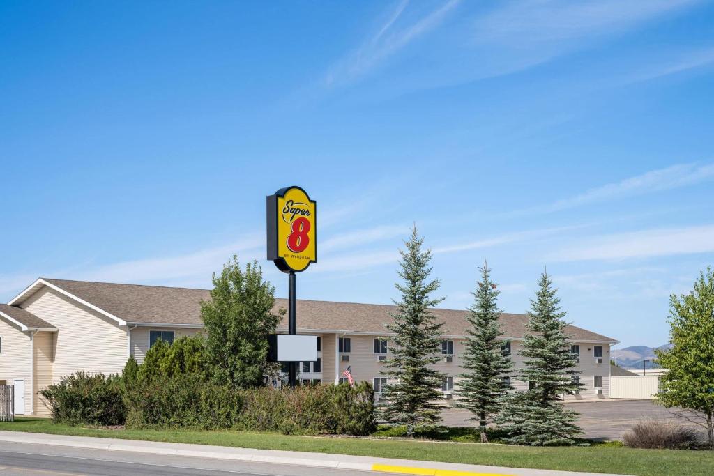 a sign on the side of a road in front of a building at Super 8 by Wyndham Lewistown in Lewistown