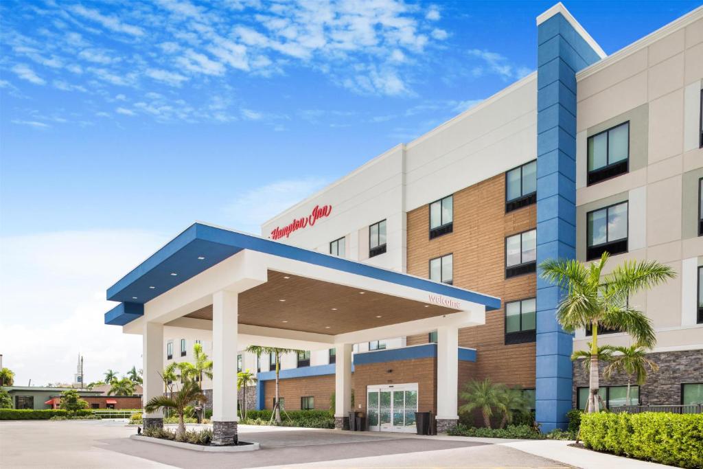 a hotel with a blue and white building at Hampton Inn Fort Myers Downtown in Fort Myers