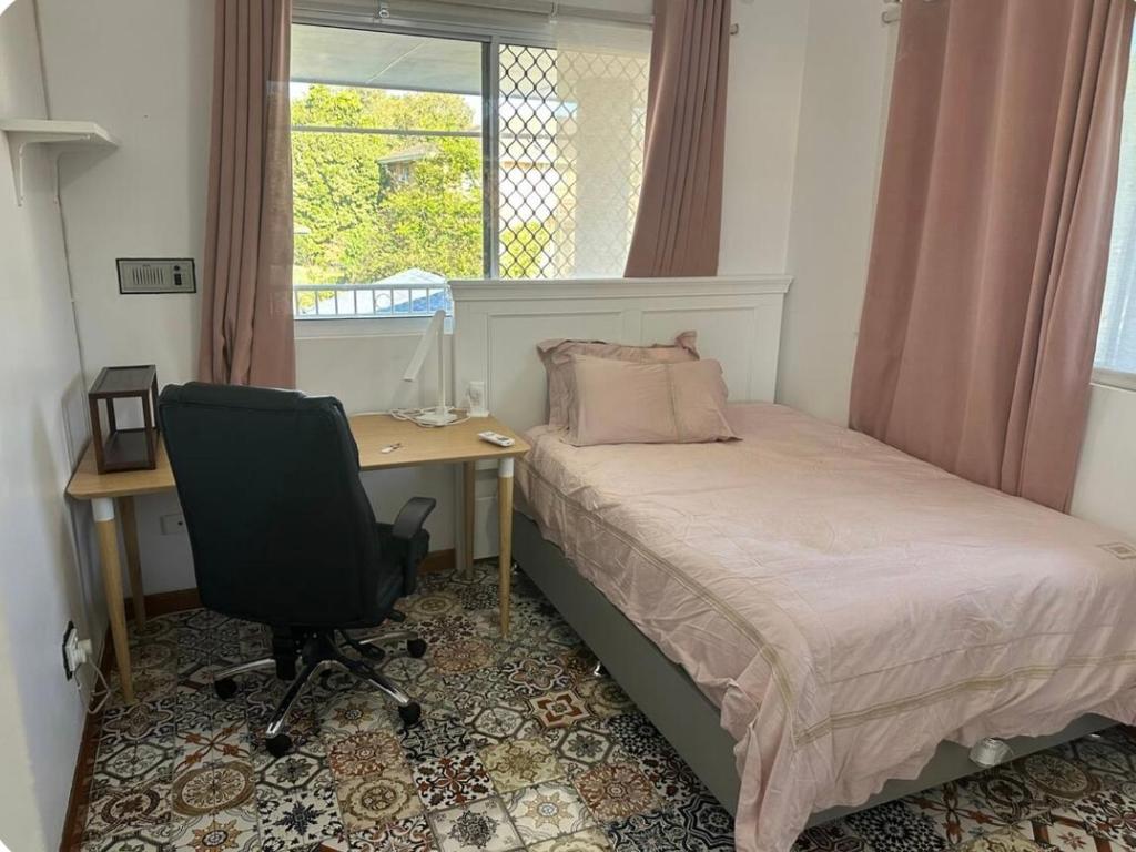 a bedroom with a desk and a bed and a chair at Mains Rd only share bathroom with one room 3 in Brisbane
