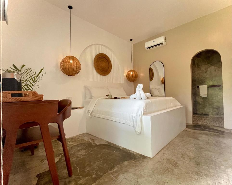 a bedroom with a bed and a desk and a mirror at MAAYONG HOSTEL in Moalboal