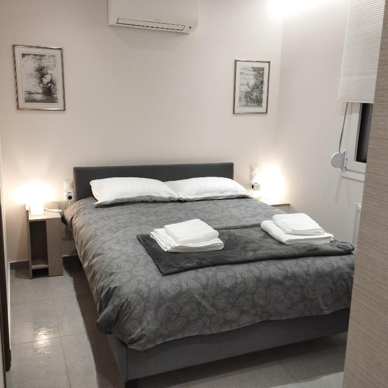 a bedroom with a bed with two towels on it at Quiet Place in Ioannina