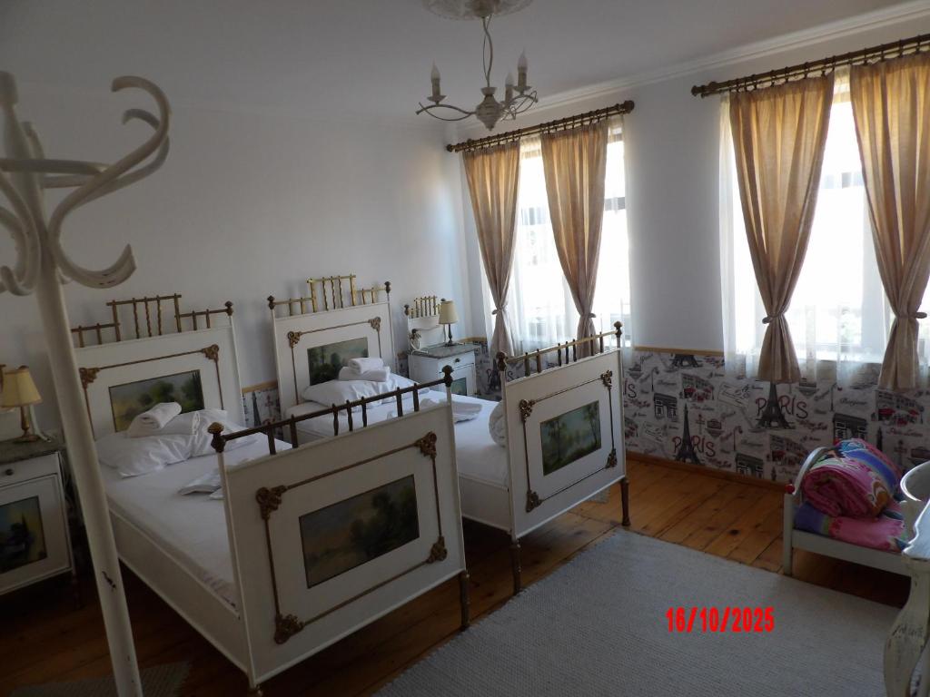 a bedroom with two beds and a couch at Етаж от Хаджи Марковата къща за гости - град Дряново in Dryanovo