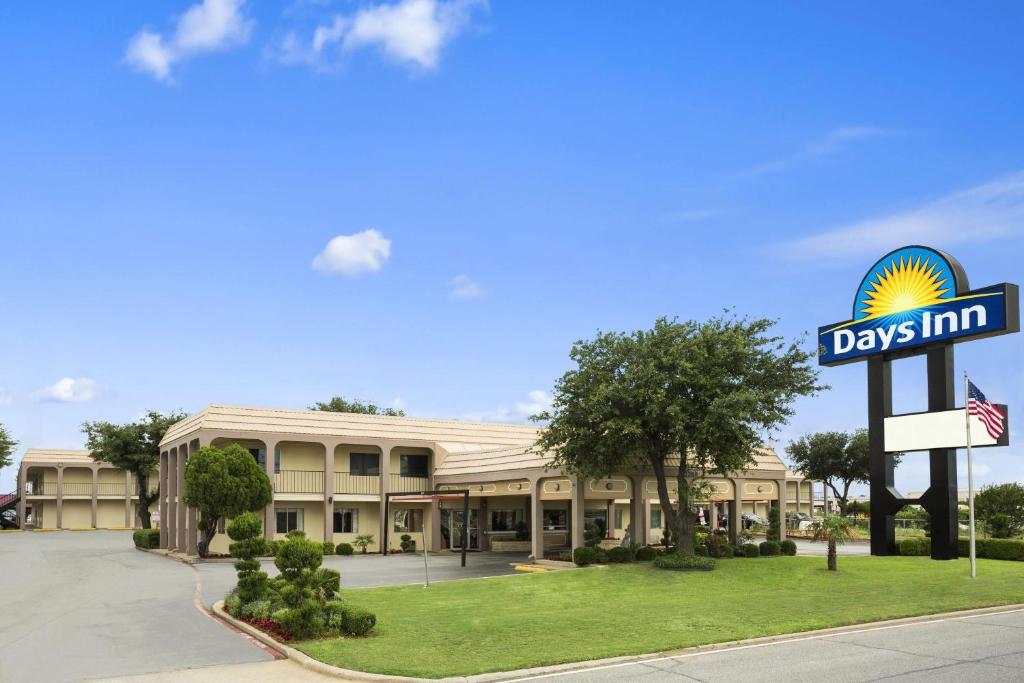 a days inn sign in front of a building at Days Inn by Wyndham Dallas Irving in Irving