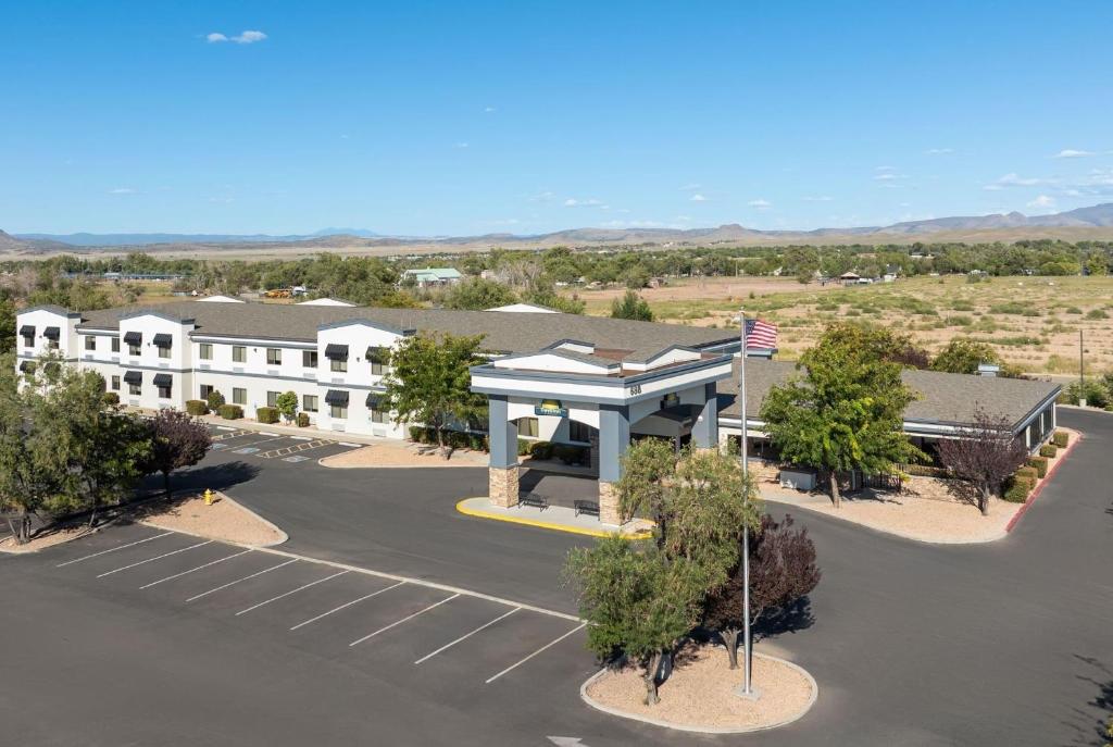 an aerial view of a building with a parking lot at Days Inn by Wyndham Chino Valley in Chino Valley