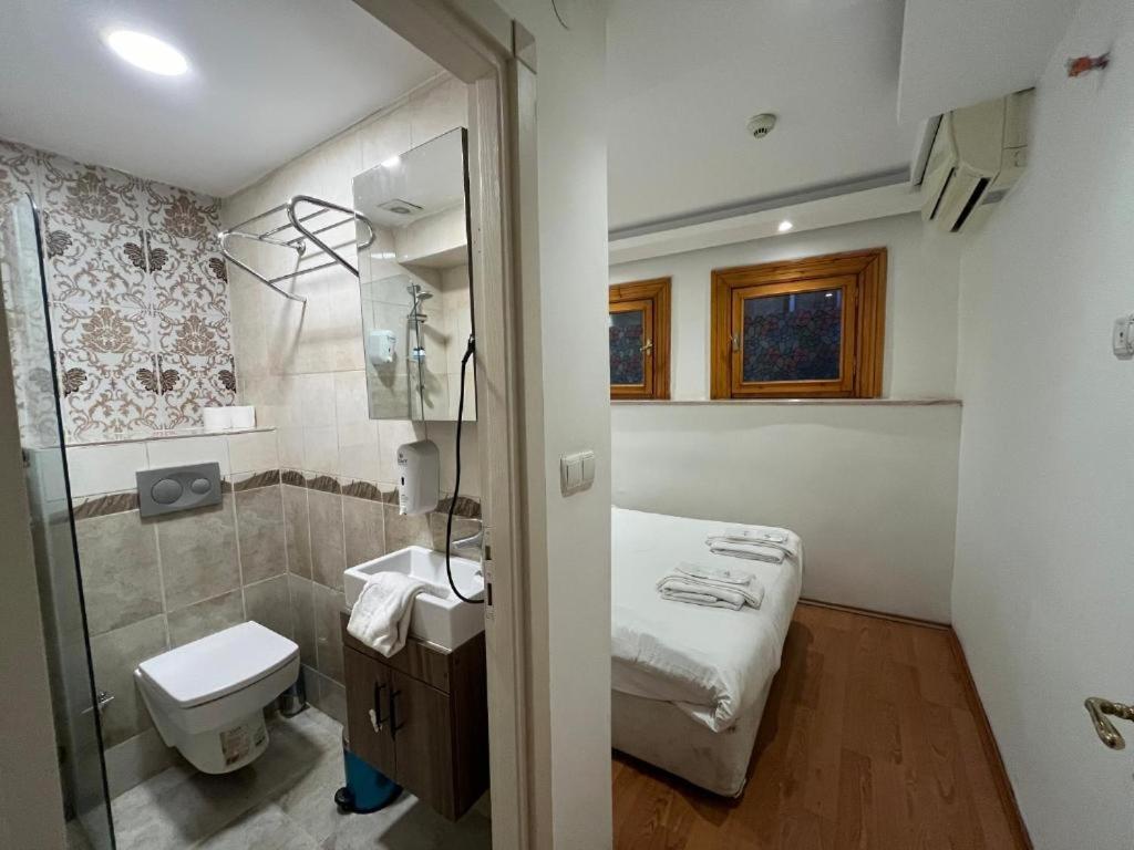a small bathroom with a bed and a shower at Le Safran Suite Hotel in Istanbul