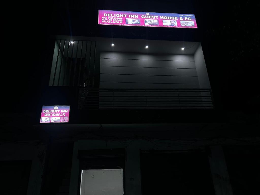 a building with a pink sign on top of it at Delight Inn Guest House & PG in Lālewāl