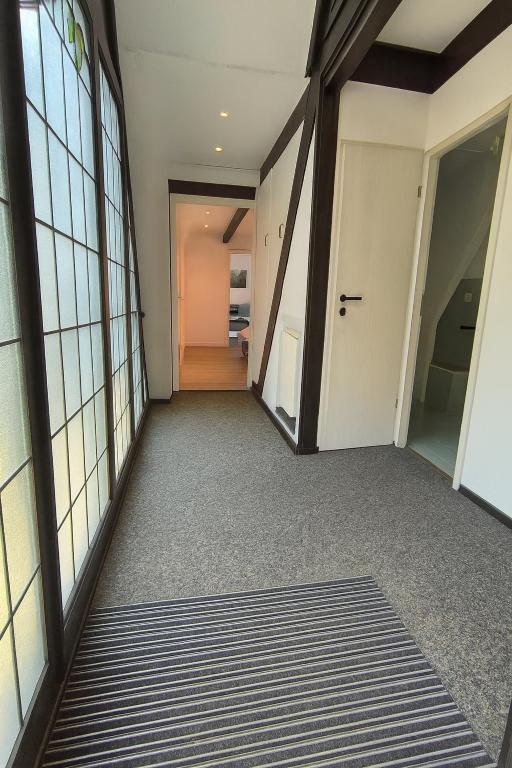 an empty hallway with a door leading to a room at Waldnest Eifel in Kerschenbach