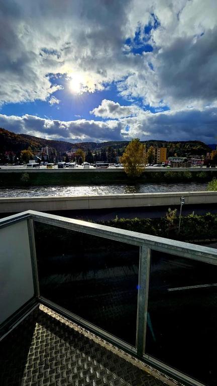 a balcony with a view of a body of water at Hron River View Apartment 24h Self check -in Free Parking in Banská Bystrica