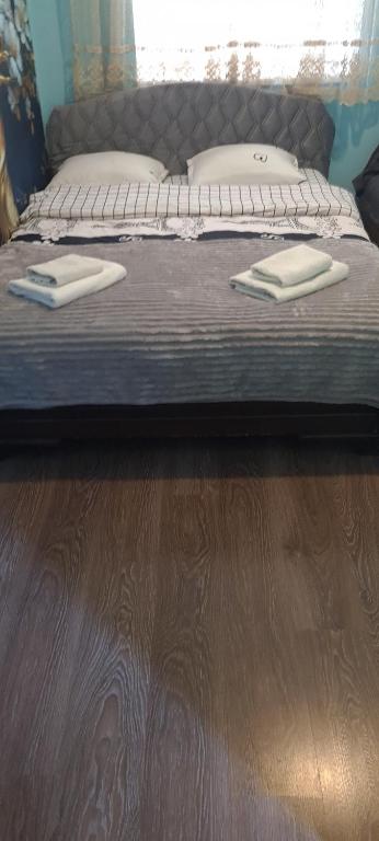 a bed with two pillows on top of it at Viktoriahotel in Tbilisi City