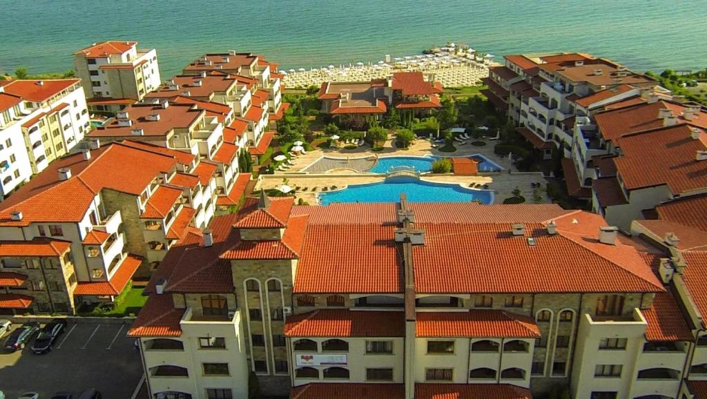 an aerial view of a city with buildings and the ocean at 5-Star Beachfront Luxury Apartments in Sveti Vlas