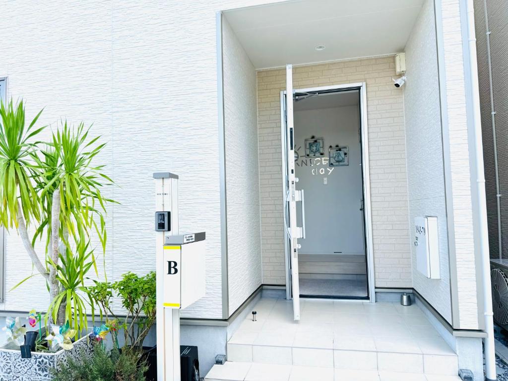 an open door on the side of a house at Naha Airport, beaches, shopping centers are nearby #NewVilla in Itoman