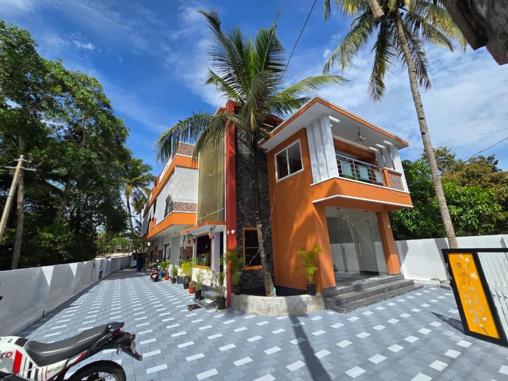 a house with a motorcycle parked in front of it at Nature's Frame Residency in Varkala