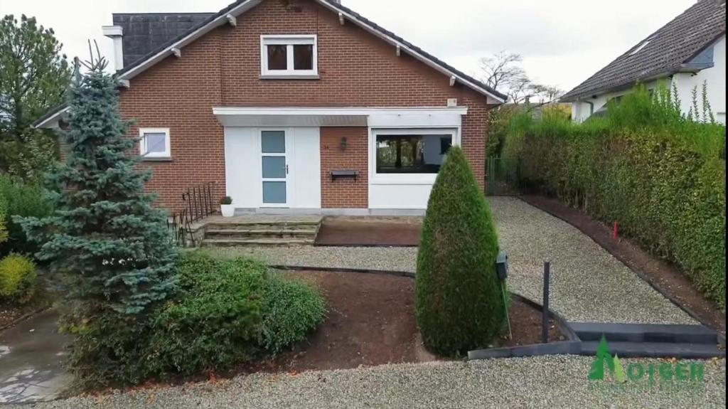 a brick house with a white door at Villa les Hauts de Heusy in Verviers