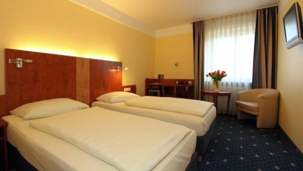 Postel nebo postele na pokoji v ubytování Aparthotel Astro - Nichtraucherhotel