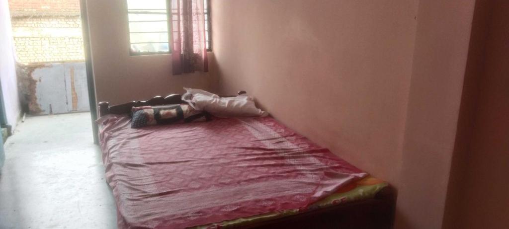 a bed sitting in a corner of a room at Hotel O Chandrapur Gadchandur formerly Hotel Relax in Chāndur