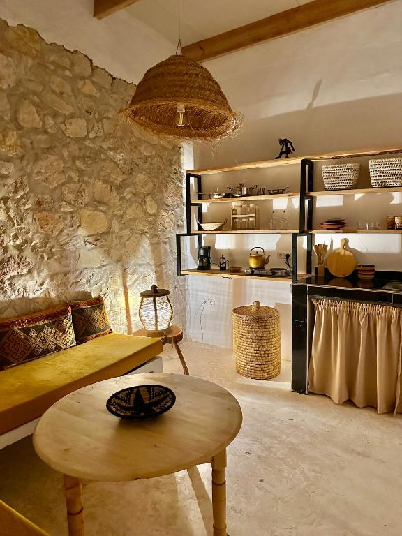a living room with a couch and a table at Cozy 1BR Bungalow with Kitchen in Eco Garden Nature Escape in Agadir