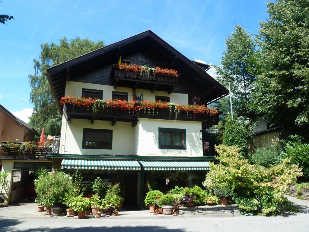 a building with flower boxes on the side of it at Gaestehaus-Staats in Obervellach