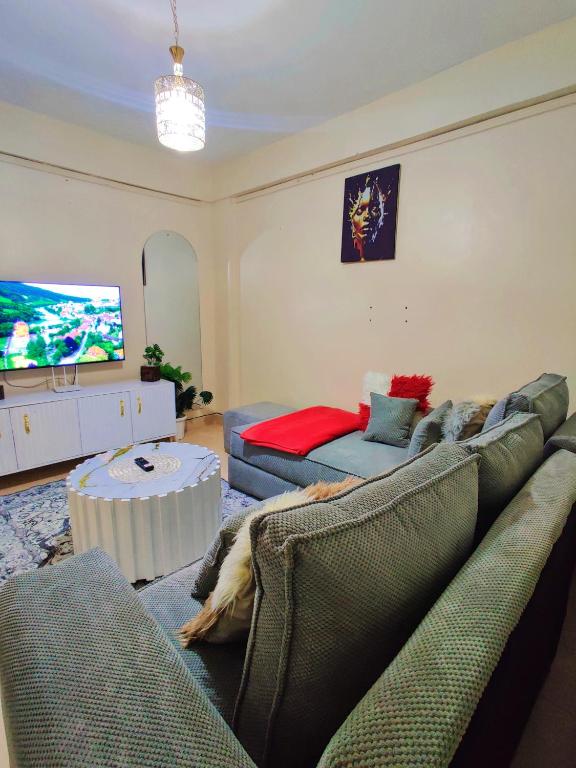 a living room with a couch and a tv at Reigns cozy corner in Eldoret