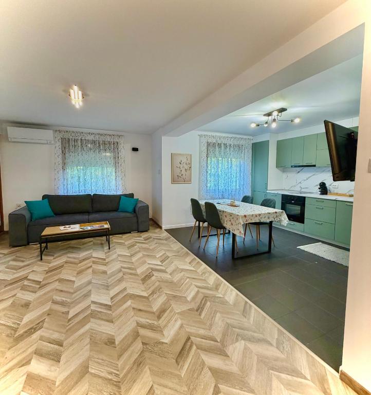 a living room with a couch and a table at Apartament Draganovi 8B in Kazanlŭk