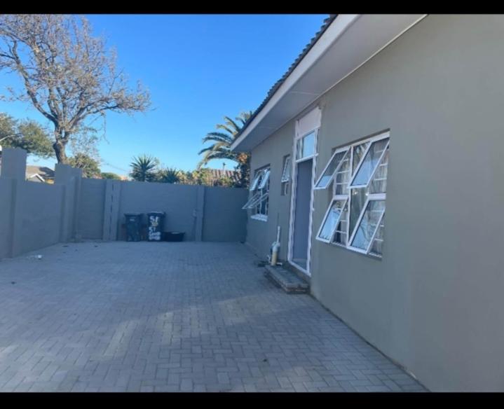 a white building with windows on the side of it at RestHaus in Goodwood