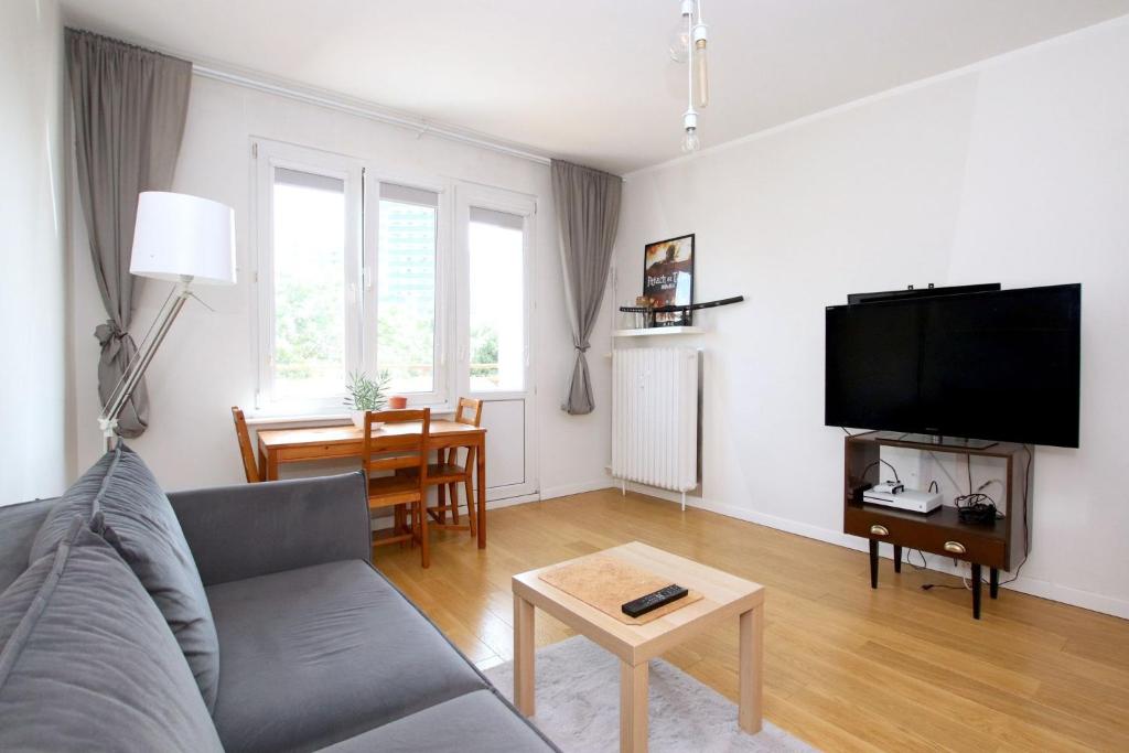 a living room with a couch and a table at Perfect Location Apartment with Balcony Oldtown in Gdańsk