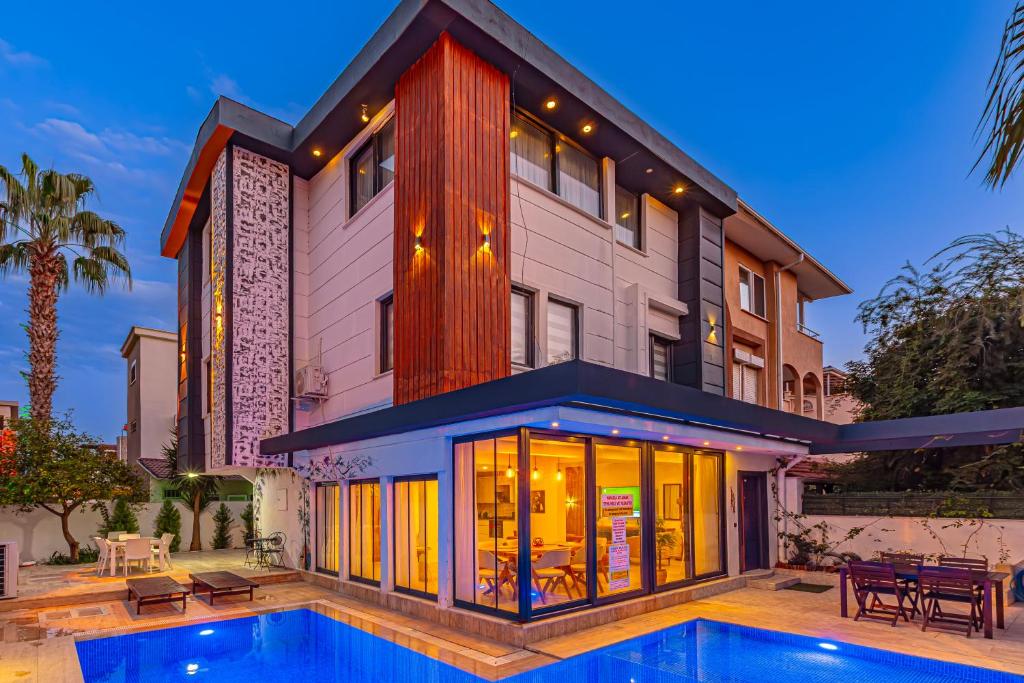 a house with a swimming pool in front of it at Casa Rosa Luxury Villa w heated Pool in Belek