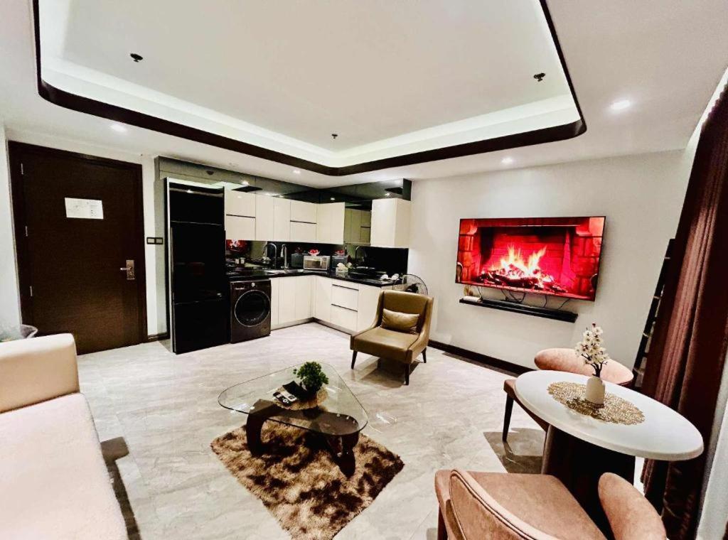 a large living room with a fireplace in the wall at One Euphoria Prime Suite Hotel Angeles city in Malabañas