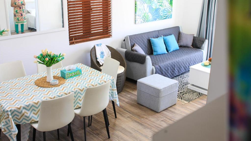 a living room with a table and a couch at Villa Omoris 3 bedrooms Trou aux Biches, Sea Access in Trou aux Biches