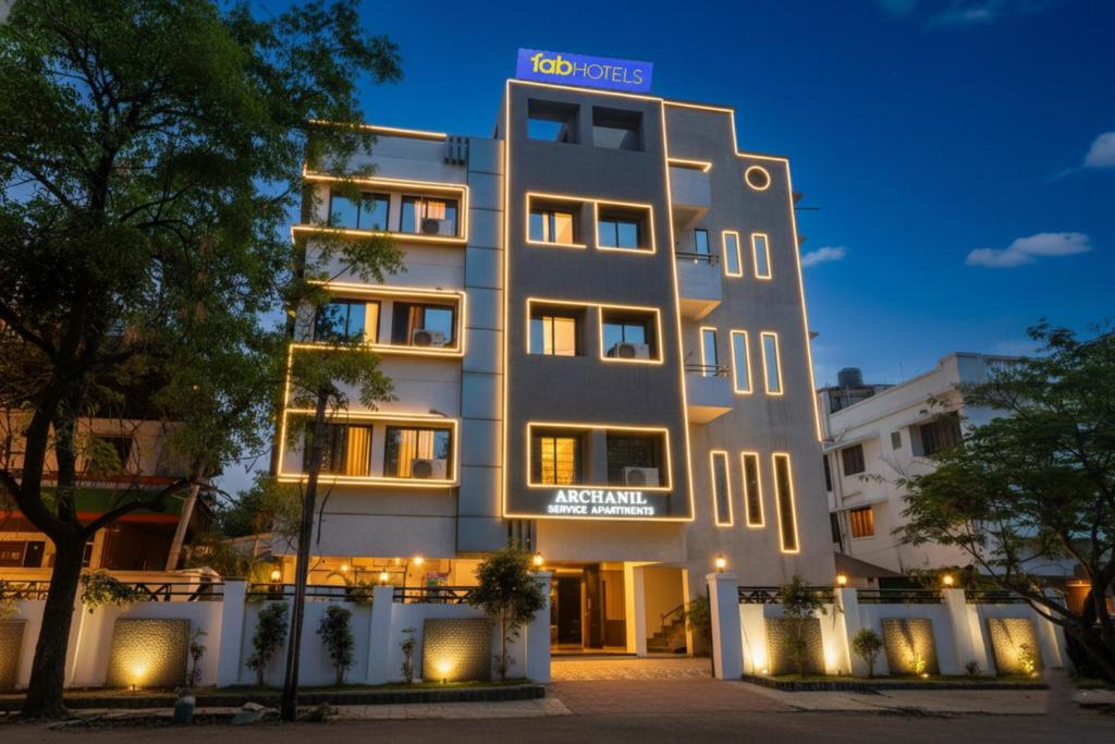 a building with a sign on top of it at FabHotel Archanil Apartment - Sitanagar Cricket Ground in Nagpur