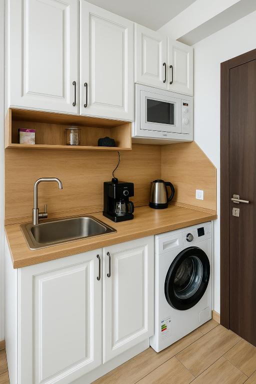 a kitchen with a sink and a washing machine at Aпартамент 5 in Varna City