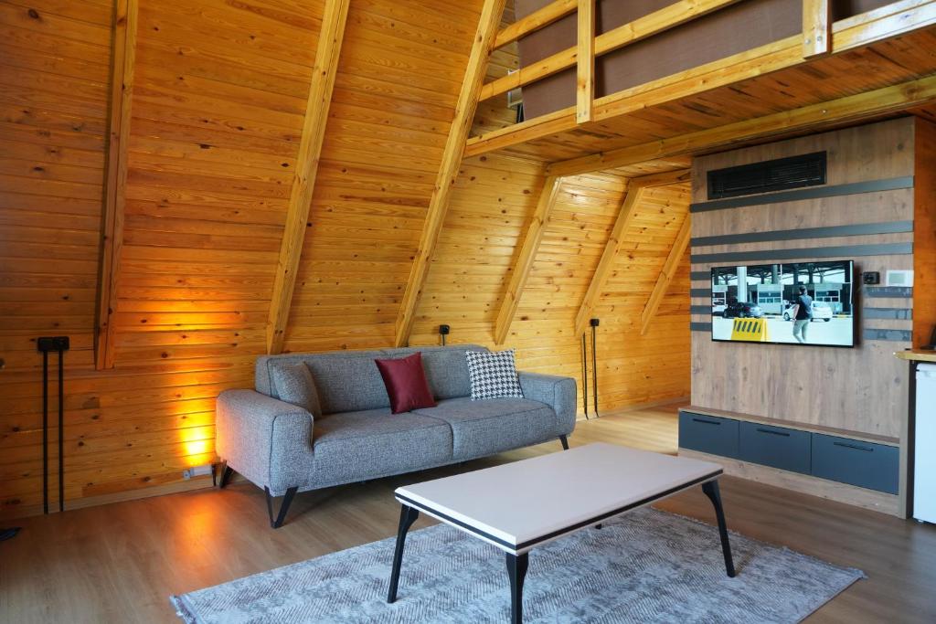 a living room with a couch and a table at Green Park Mardin Hotel 