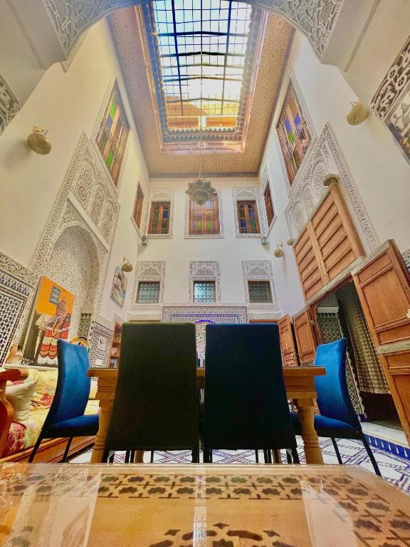 a dining room with a table and chairs at RIAD LALJ Fes in Fez