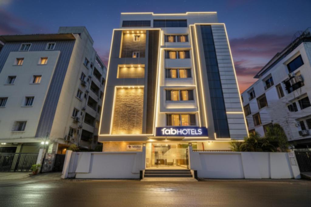 a building with a sign on the front of it at FabHotel Prime Veeraj Suites- Nr Skyview10, Lumbini Avenue, Gachibowli in Hyderabad
