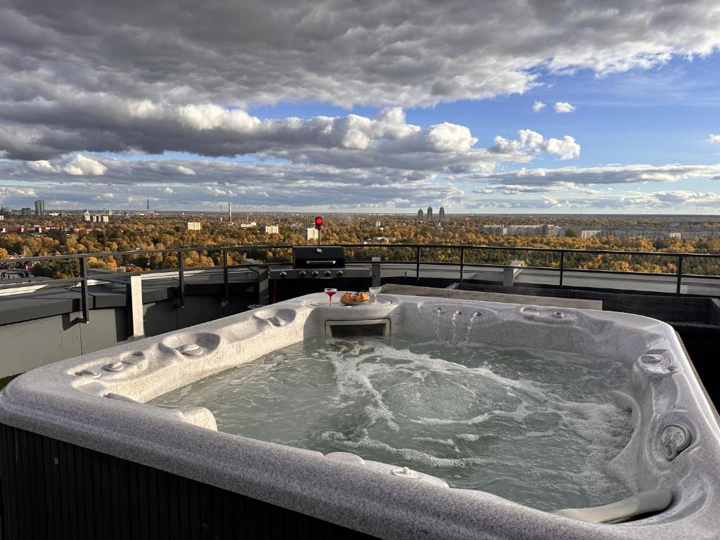 a jacuzzi tub on the roof of a building at Skyhouse Riga Relax Penthouse And Spa in Rīga