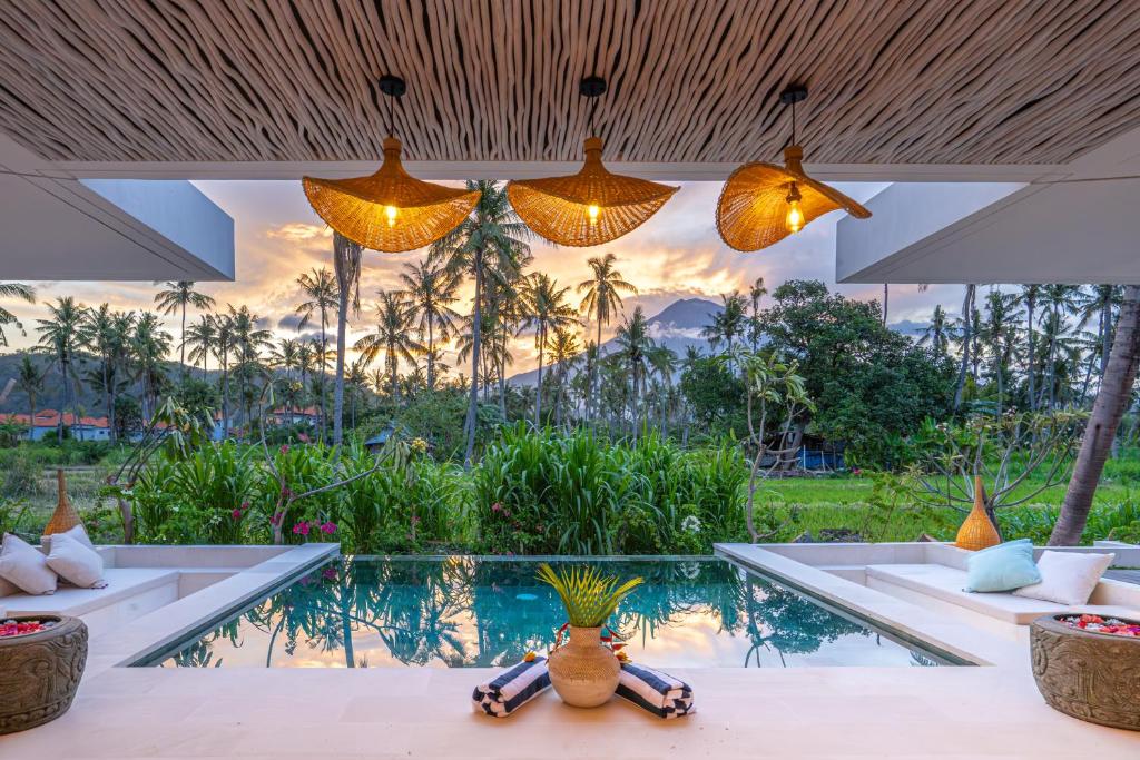 a resort with a swimming pool and lights at OMAÏA Private villas in Amed